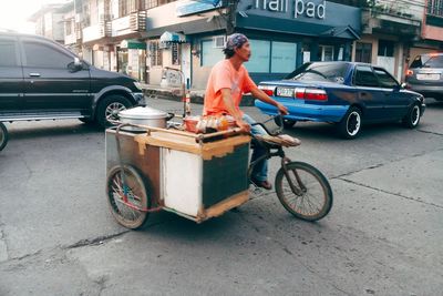 Man with bicycle on street