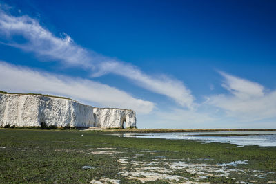 Built structure on land against blue sky