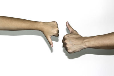 Close-up of hands over white background