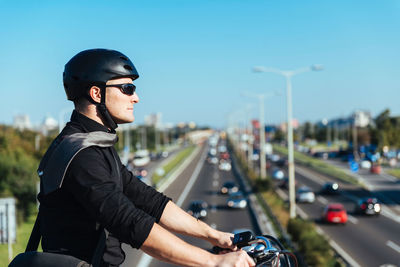 Side view of businessman riding bicycle