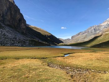 Scenic view of lake and mountains against sky