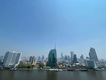 Modern buildings in city against clear sky