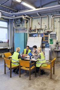 Manual workers discussing in factory