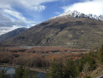 Scenic view of mountains against cloudy sky