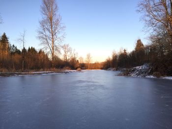 Scenic view of frozen lake against clear sky during winter