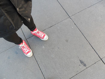 Low section of person relaxing on tiled floor