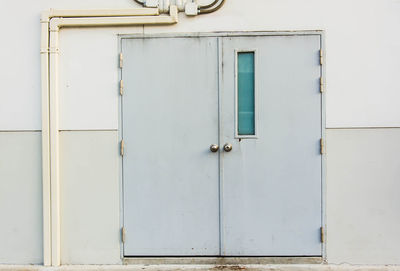 Closed white door of building