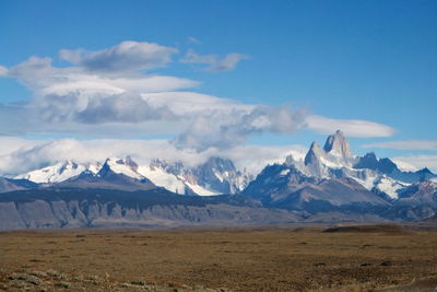 Scenic view of mountains against cloudy sky