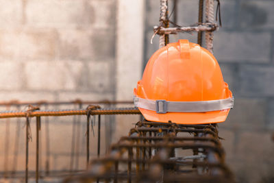 Close-up of orange container against wall