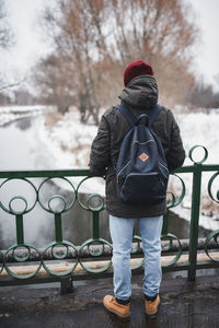 Low section of man standing on snow