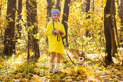 Full length of a girl standing in forest