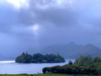Scenic view of sea and mountains against sky