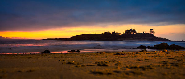 Scenic view of beach against sky during sunset. o santo island in marin, pontevedra