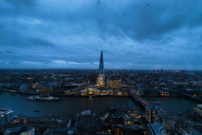 High angle view of city lit up at dusk