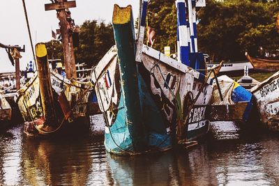 Boats moored in river against sky