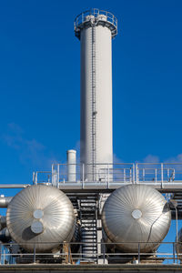 Low angle view of smoke stack against sky