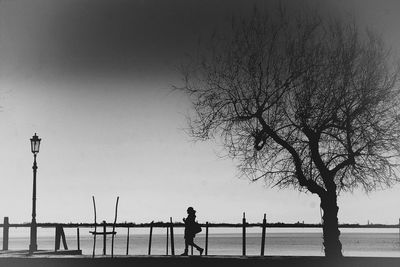 Silhouette of man on road against sky