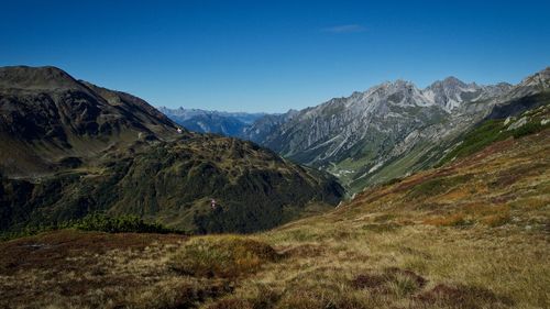 Scenic view of mountains against clear blue sky