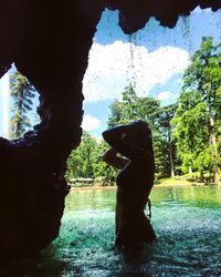 Statue amidst trees against sky