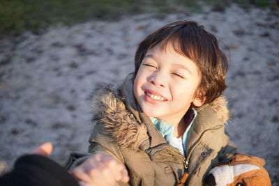 Portrait of smiling boy in snow