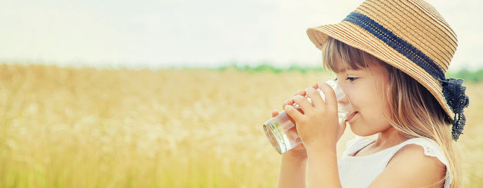 Young woman drinking wine in park