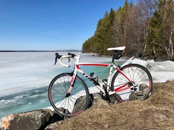 Bicycle by road against sky