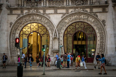 Group of people walking in historic building