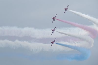 Low angle view of airplane flying in sky