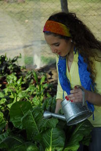 Girl standing against plants