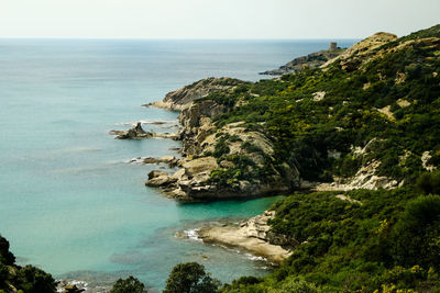 High angle view of cliff by sea against sky