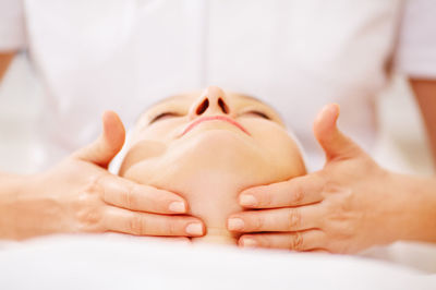 Close-up of woman getting beauty treatment from doctor