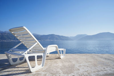 Beach chair on the background of the sea and mountains in montenegro