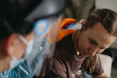 Doctor examining patient at home