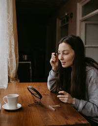 Young woman reading book at home