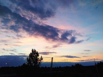 Low angle view of silhouette trees against sky at sunset