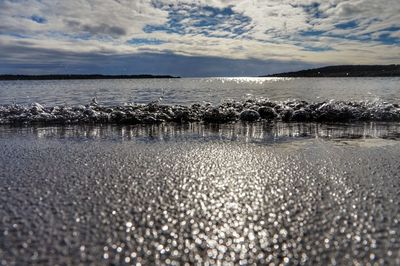 Scenic view of sea against cloudy sky