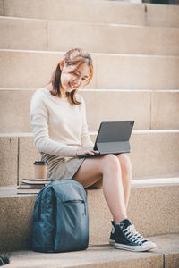 Young woman using laptop while sitting at home