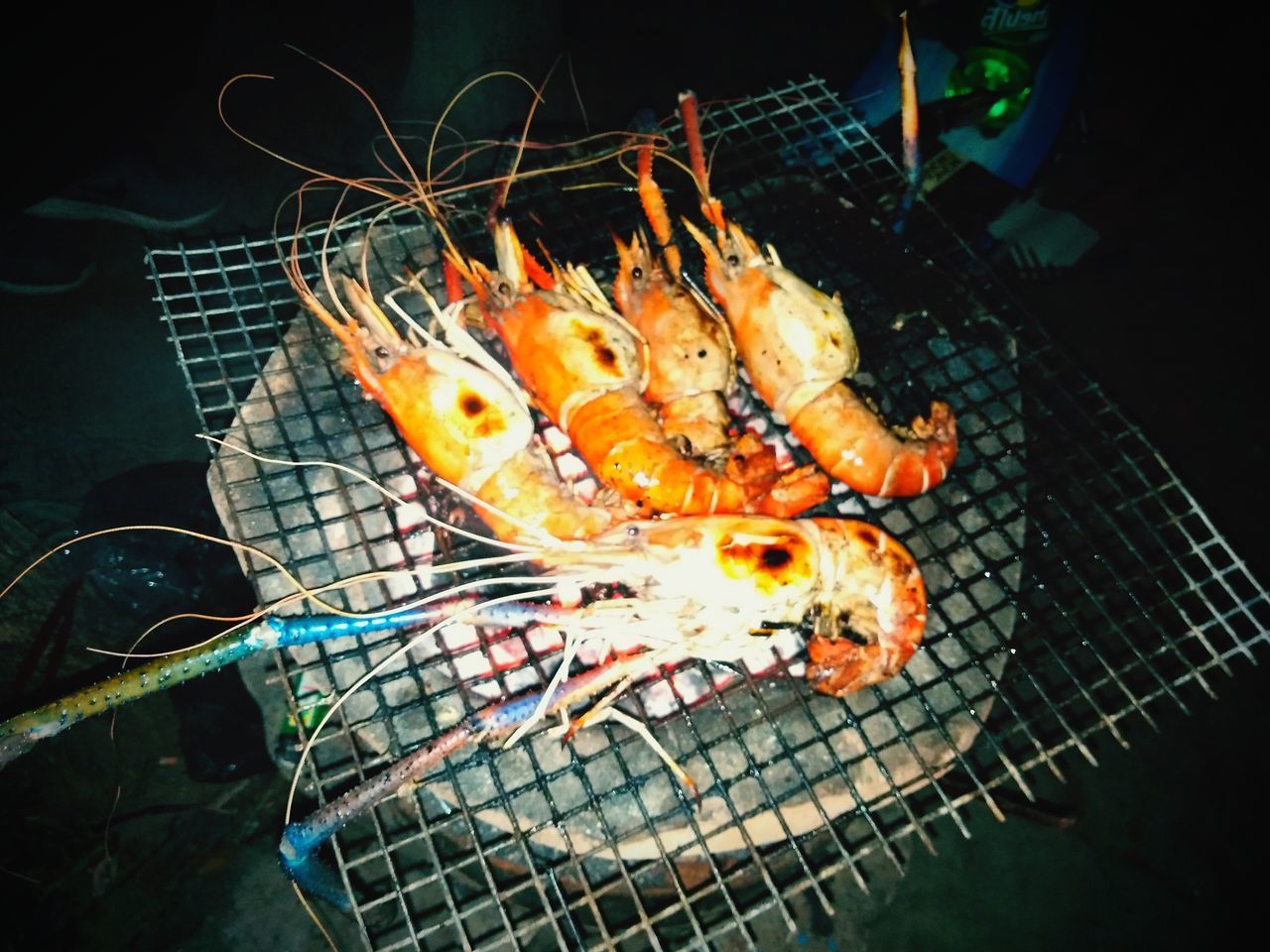 HIGH ANGLE VIEW OF FISHES ON BARBECUE GRILL