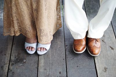 Low section of people standing on wooden floor