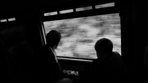 Silhouette of men in train