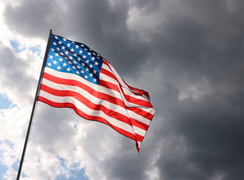 Low angle view of flag against sky