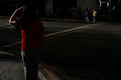 Women standing on street in city at night