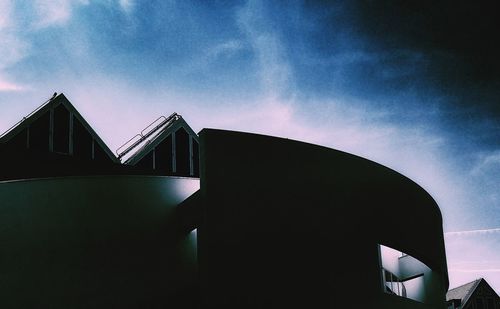 Low angle view of silhouette building against sky