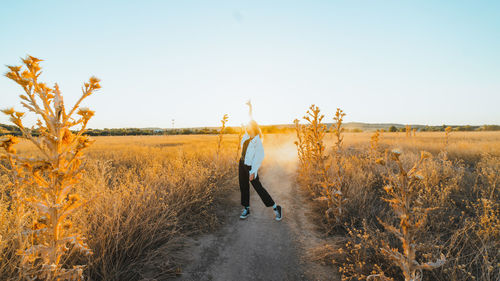 Man standing on field against clear sky