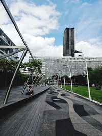 View of footbridge against cloudy sky