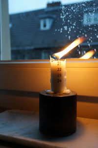 Close-up of illuminated tea light candles on table