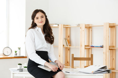 Portrait of smiling young woman at office