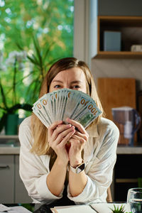 Portrait of young woman reading book