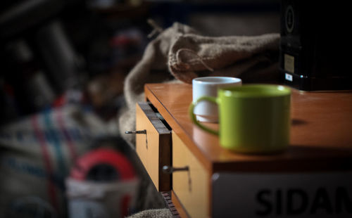 Coffee cups on wooden table at home