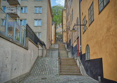 Low angle view of staircase amidst buildings in city